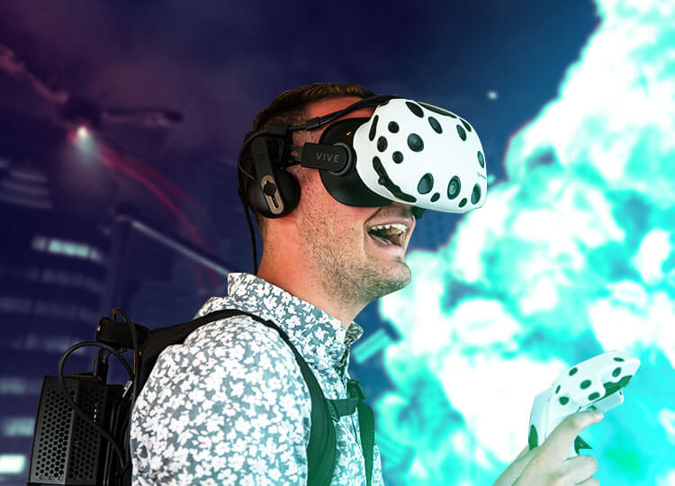 Player in a VR escape room wearing HTC Vive virtual reality equipment